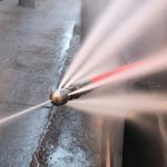 High-pressure water jet nozzle in action, demonstrating hydro jet drain cleaning capabilities, relevant to plumbing services offered by Chris Wilson Plumbing & Heating Repairs Inc.