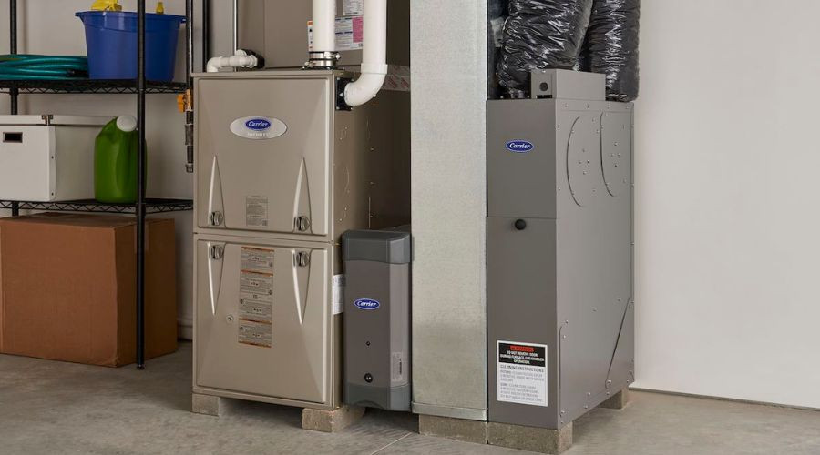 Heating system installation featuring a Carrier furnace and air conditioning unit in a garage setting, emphasizing HVAC services relevant to Chris Wilson Plumbing & Heating Repairs Inc.